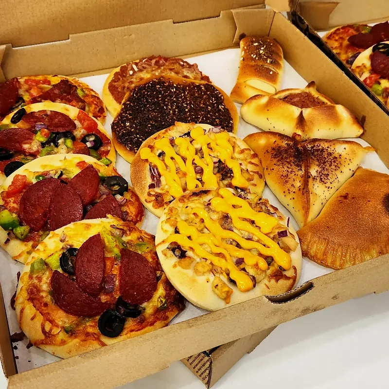 A box of mixed manoush and pizzas: pepperoni, za'atar, cheese and meat